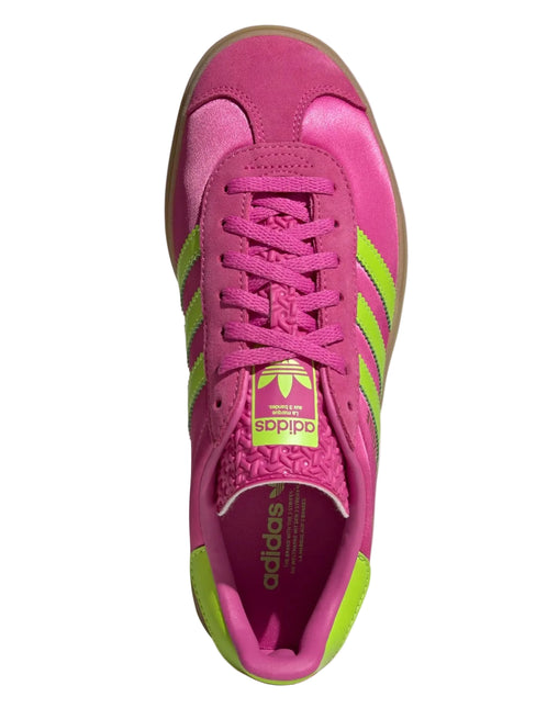 Pink Adidas sneaker with green accents on a light gray background