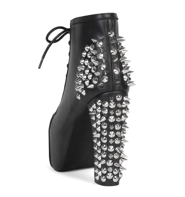 Black high-heeled boot with silver spikes on a white background